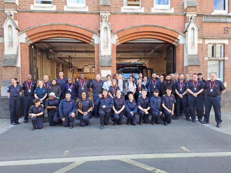 LFB staff and fire cadets in a group photo outside fire station