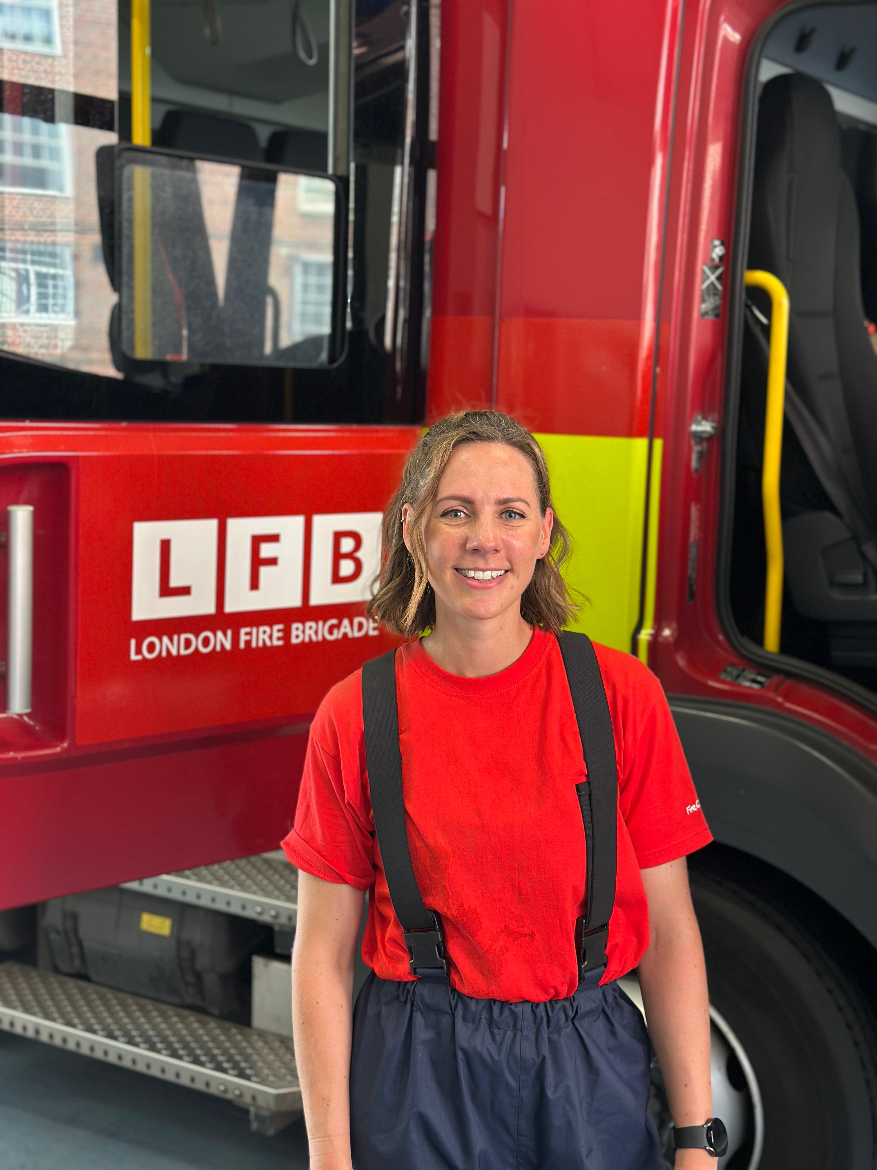 A VCI stands in front of a fire engine.