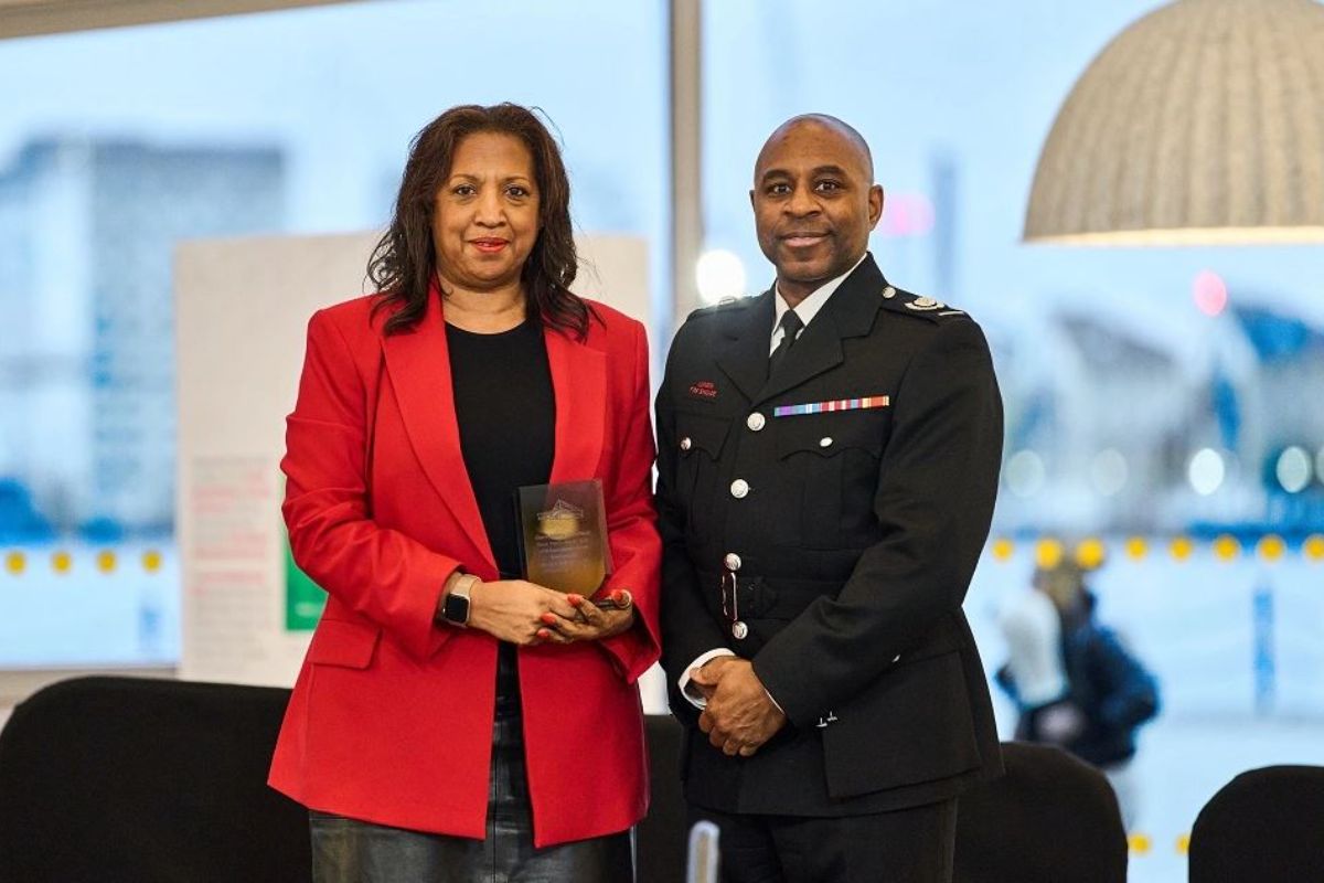 Clare Adams Crawford and Kevin Mackenzie holding an award