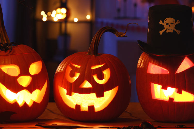 Carved, grinning pumpkins lit from within.