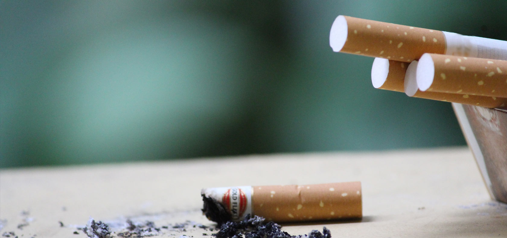 Cigarettes stub on a stable and ash tray  
