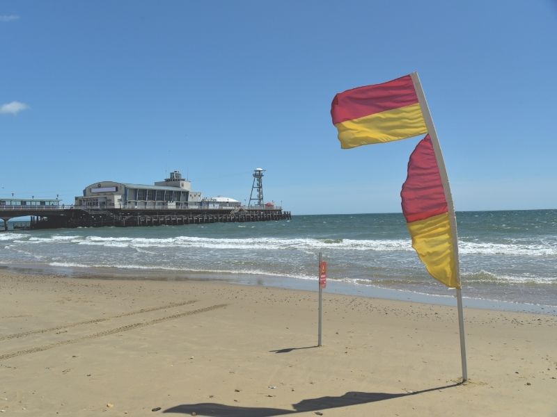 Red and yellow warning flags on a beach.