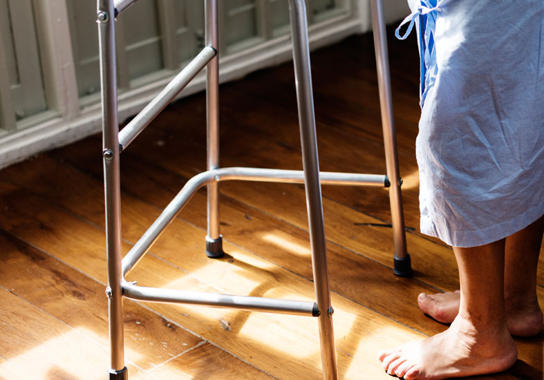 Hospital patient holding a zimmer frame 