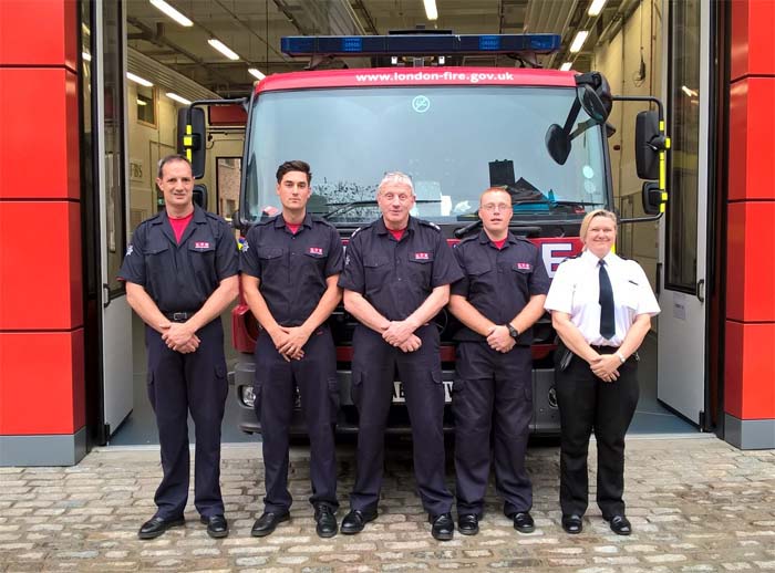 Firefighters in front of fire engine 