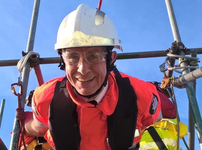 Previous Commissioner Ron Dobson in hi-vis and helmet ready to zip wire across the Thames 
