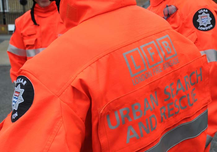 Orange hi visibility jacket with the words Urban Search and Rescue on the back