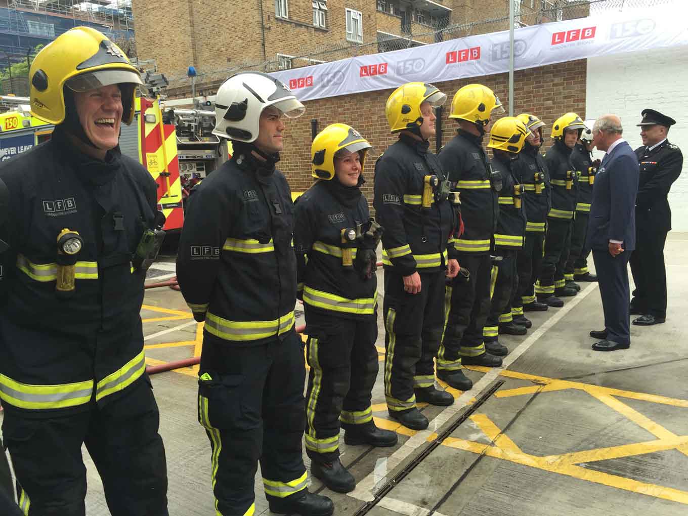 Firefighters lined up waiting to shake hands with Prince Charles 