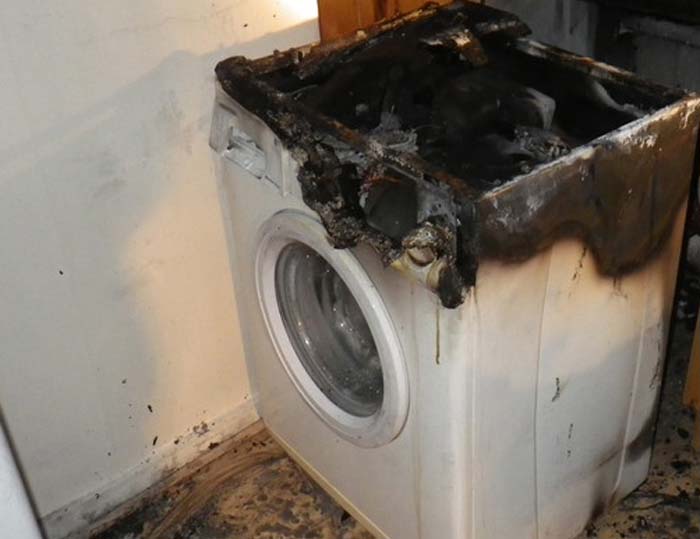 White washing machine damaged by fire 