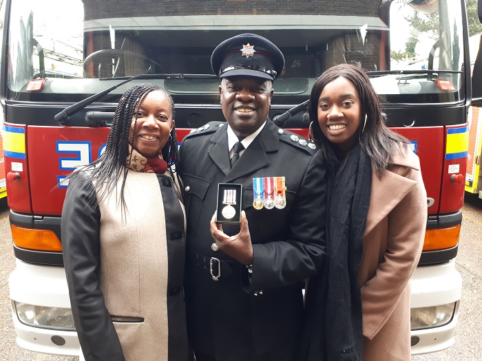 Carl St Paul Station Manager standing in front of fire engine with family 