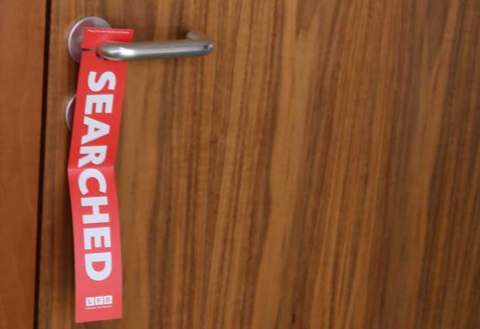 Red searched tag on a door handle