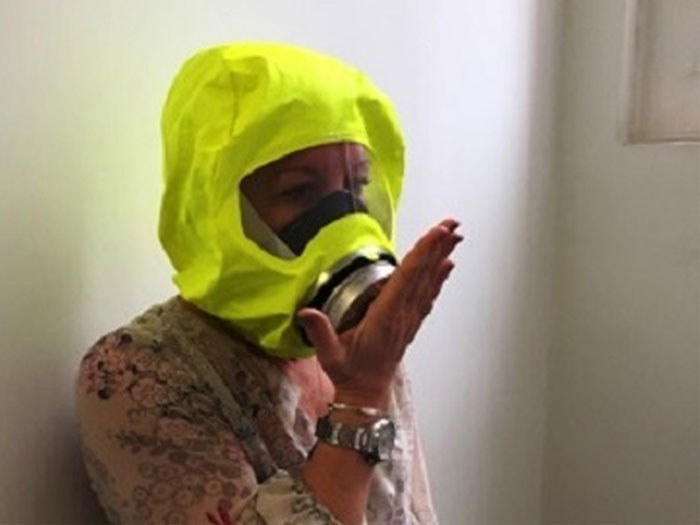 Woman wearing fire escape hood