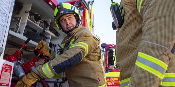 Firefighter demonstrating use of equipment