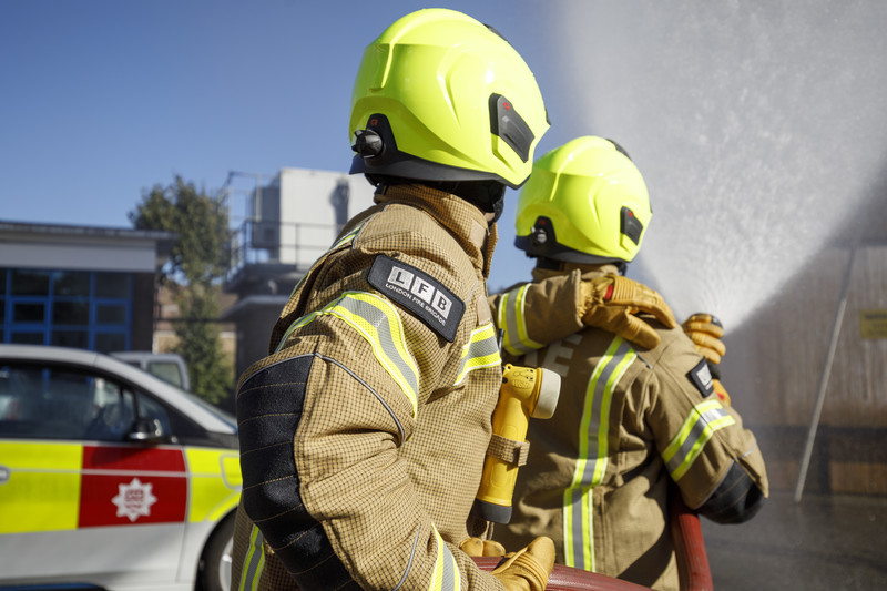 Firefighters using a hose
