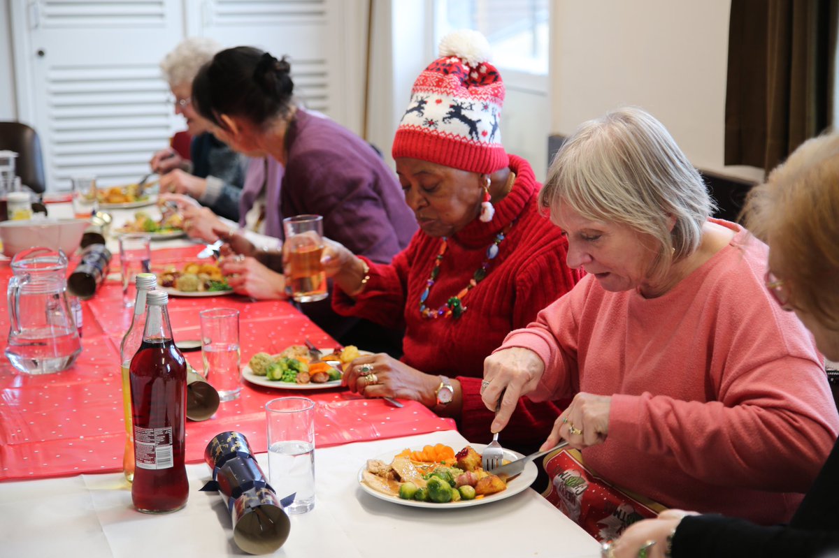 Guests enjoying their Christmas dinner in a fire station.