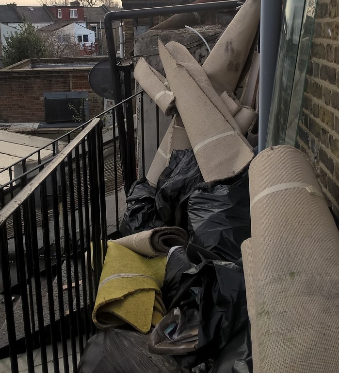 Emergency exit route blocked by rubbish