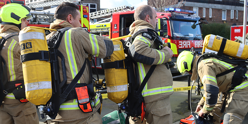 Firefighters putting on their Breathing Apparatus sets during a training exercise 