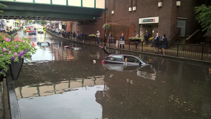 Cars partially submerged on flooded road