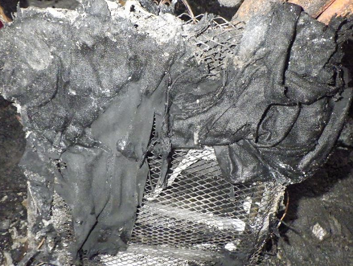 Burnt portable heater with clothes on top
