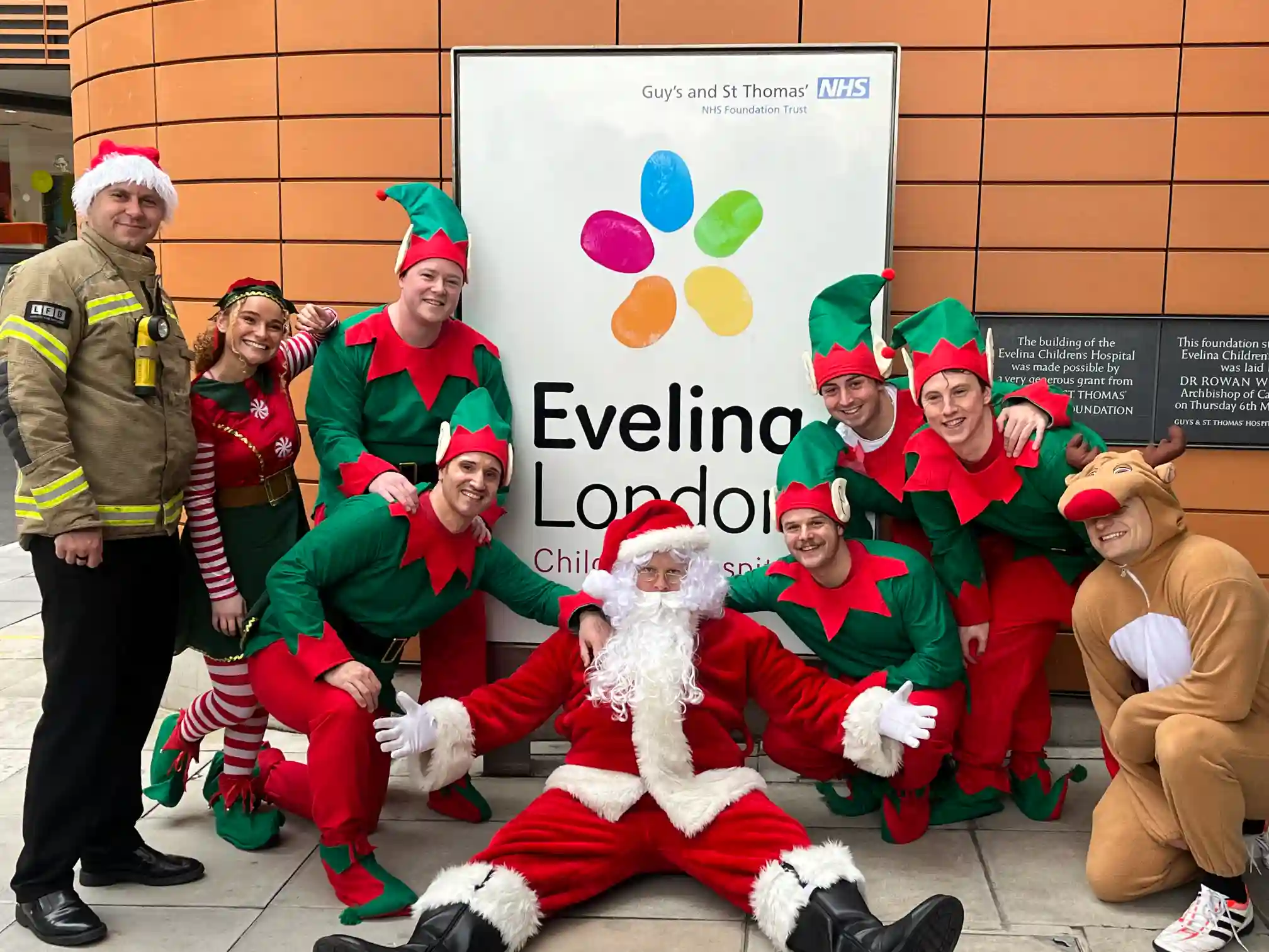Santa outside Guy's and St Thomas hospital with his elves
