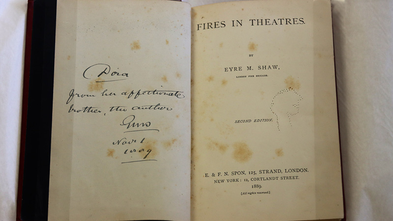 Inside the front cover showing an inscription from Chief Officer Captain Sir Eyre Massey Shaw