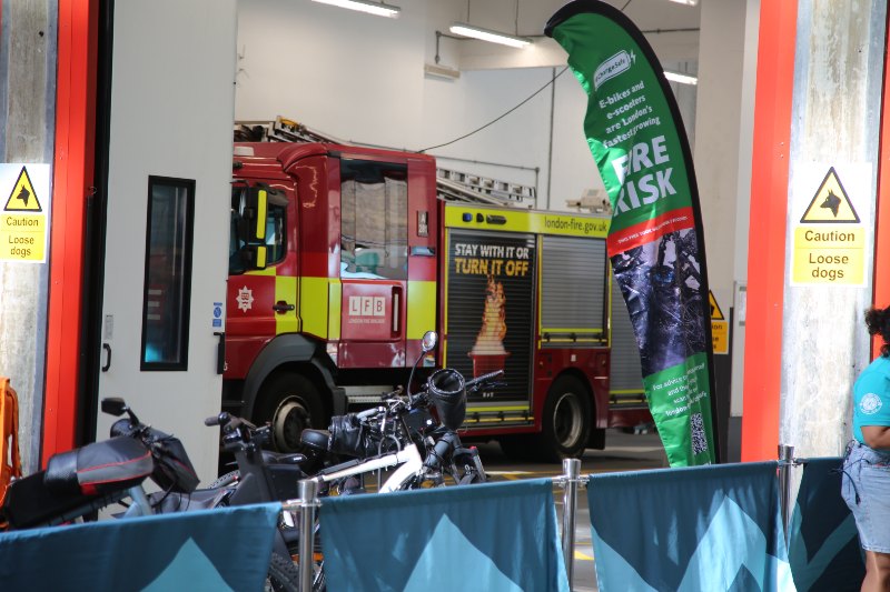 A fire engine, e-bikes and a #chargesafe sign depicting fire risks.