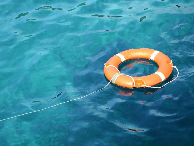 Orange life ring floating in water.