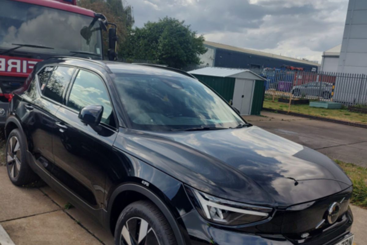 A black Volvo XC40 in a yard