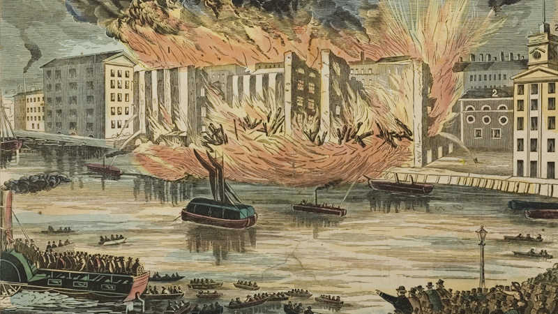 A massive crowd of people gathered along the banks of the river Thames watching the fire engulf the warehouse and parts of the building start to fall.