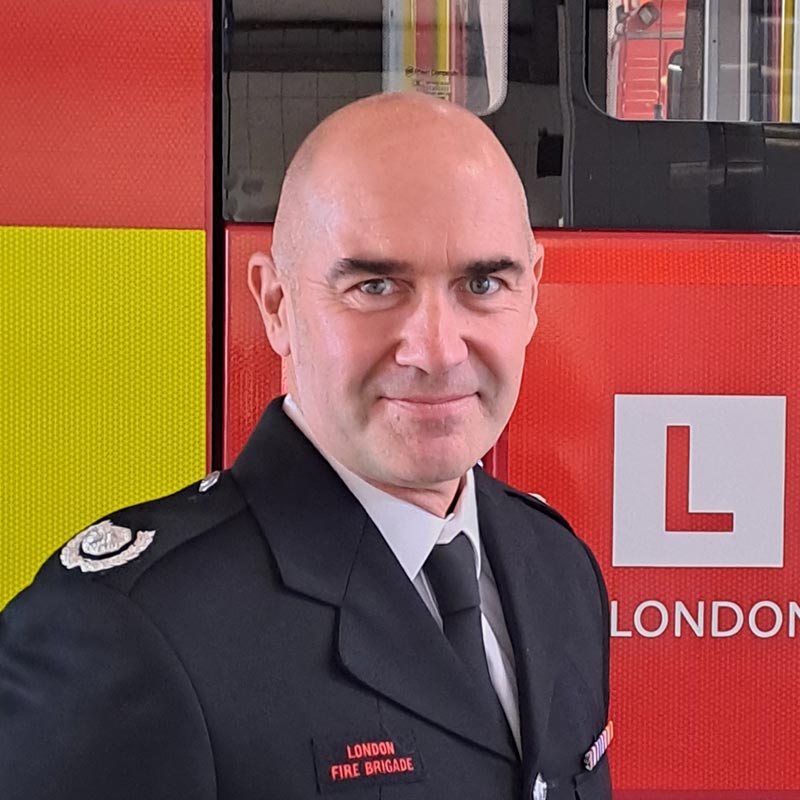 Borough Commander Mick Palmer in front of a fire engine.