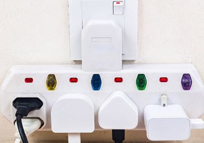 An extension lead with five plugs attached to it.