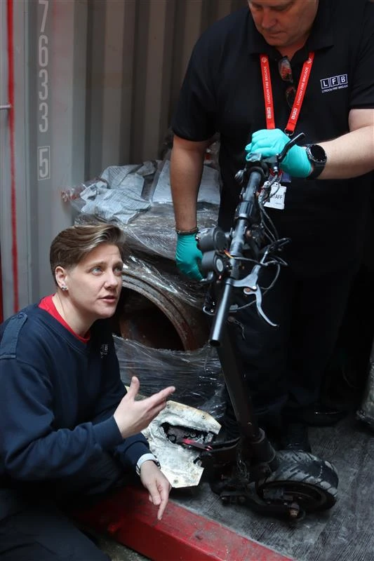 Fire Investigator Lisa Wincott and Steve Girling showing a burnt e-bike