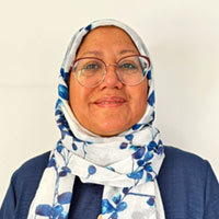 Sufia Alam, smiling while wearing blue and white.