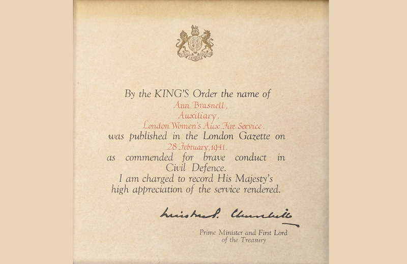 Certificate from the then Prime Minister Winston Churchill, commending AFS Firewoman Anne Brasnell for her actions during the bombing incident in September 1940. Full text below.