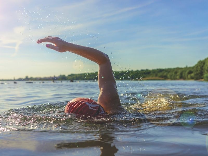Person in lake swimming front crawl.
