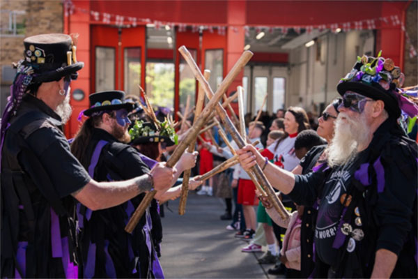 Morris dancers performing outside Dockhead Fire Station.