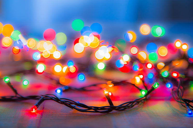 A string of colourful fairy lights glowing brightly.