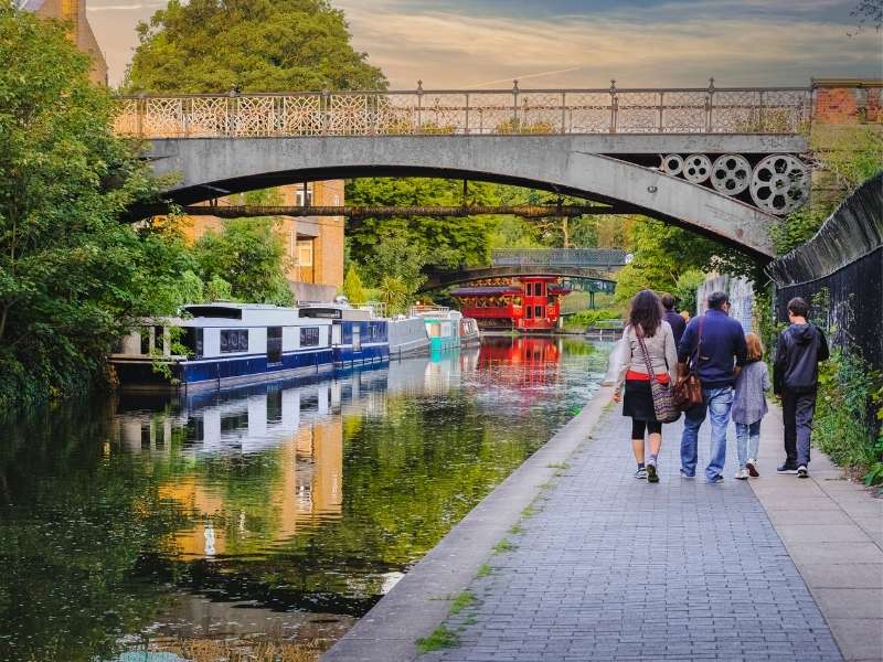 Family walking alongside canal.