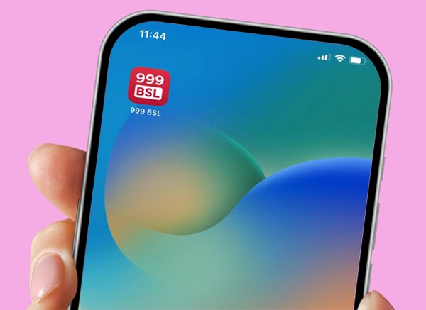 A hand holding a phone with the 999 BSL app on